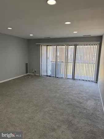 a living room with stainless steel appliances kitchen island granite countertop a refrigerator stove and sink