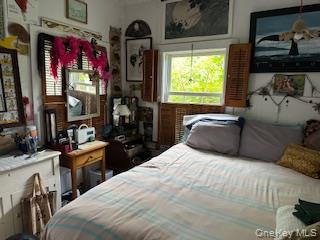 263 E Walk Ocean Beach, NY 11770 - Photo 4 of 6 a bedroom with a bed window and dresser