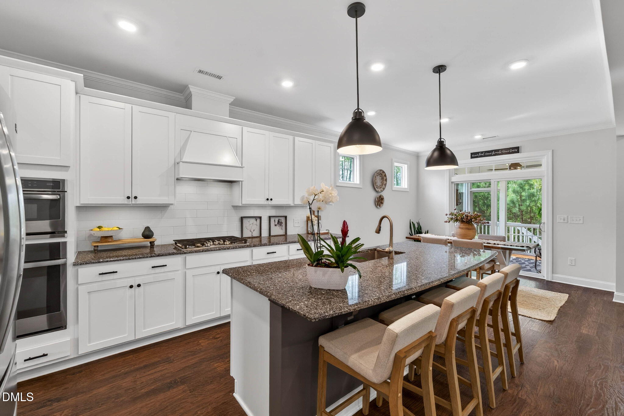 721 Hydrangea Field Court Wake Forest, NC 27587 - Photo 20 of 71 a kitchen with granite countertop white cabinets and stainless steel appliances
