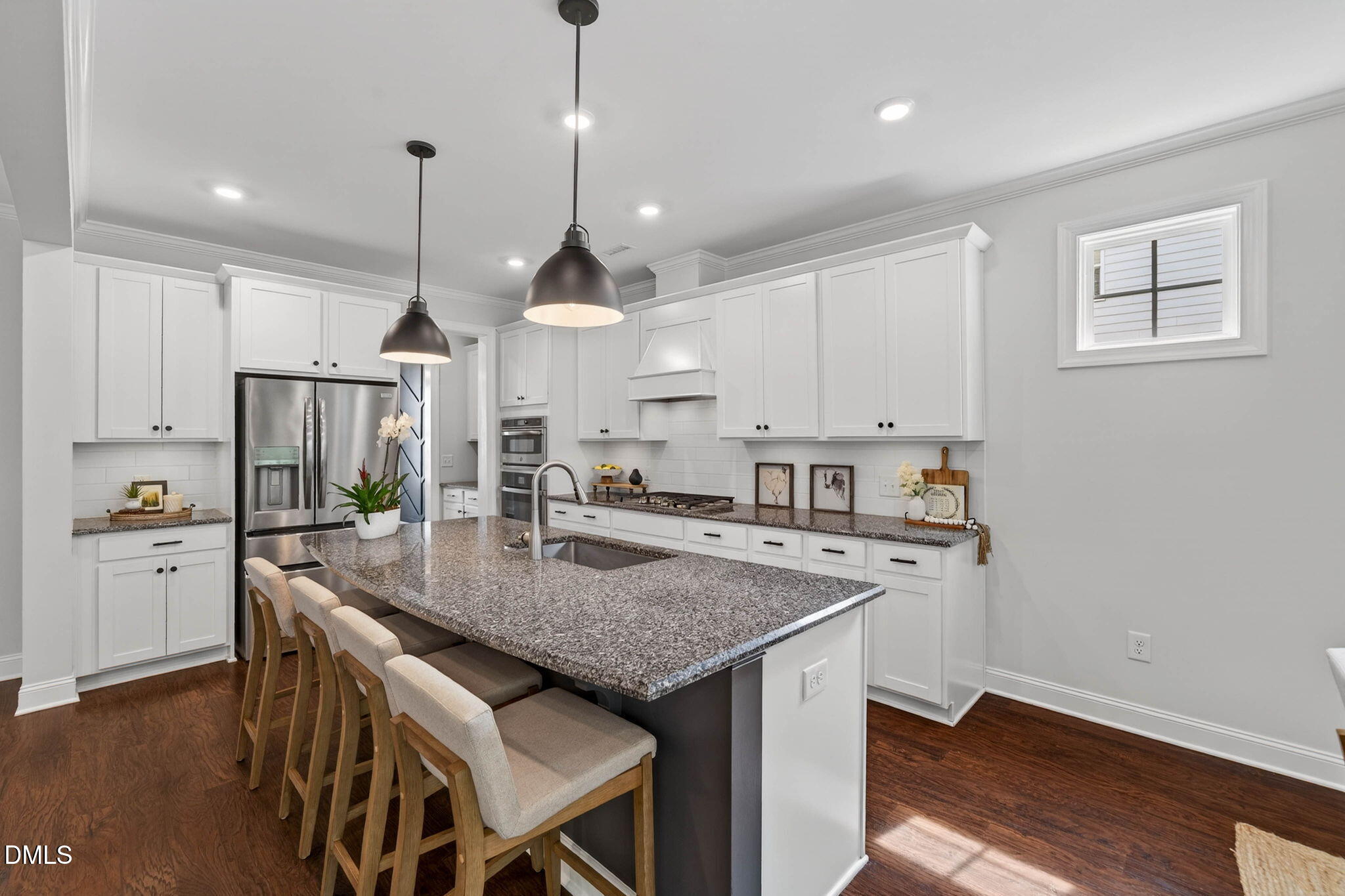 721 Hydrangea Field Court Wake Forest, NC 27587 - Photo 23 of 71 a kitchen with stainless steel appliances granite countertop a kitchen island a stove a sink a refrigerator white cabinets and wooden floor