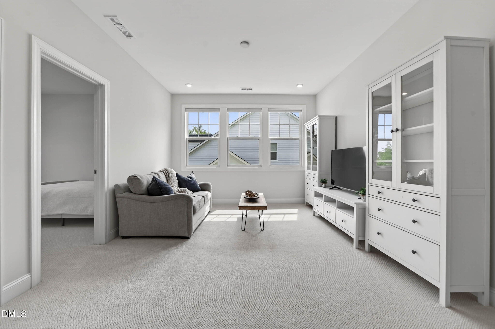 721 Hydrangea Field Court Wake Forest, NC 27587 - Photo 37 of 71 a living room with furniture and a flat screen tv