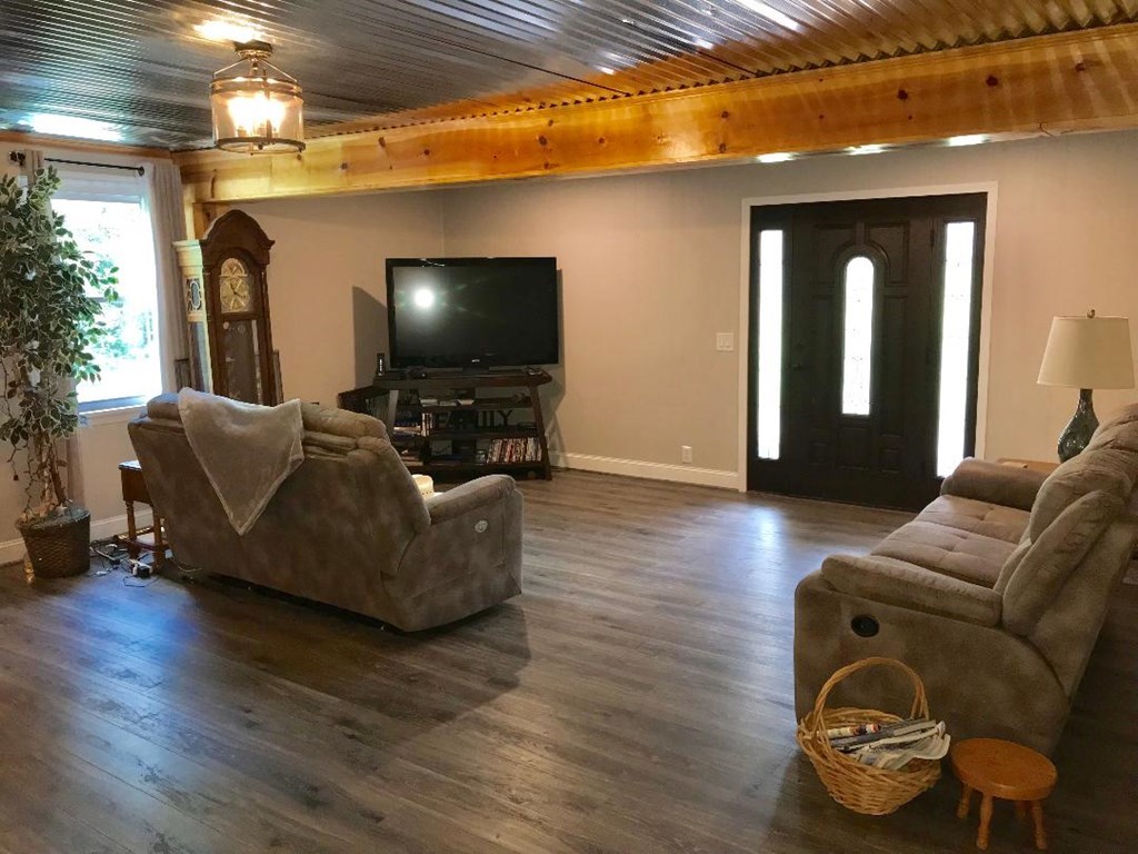 164 Hester Road Forsyth, GA 31029 - Photo 8 of 37 a living room with furniture and a wooden floor