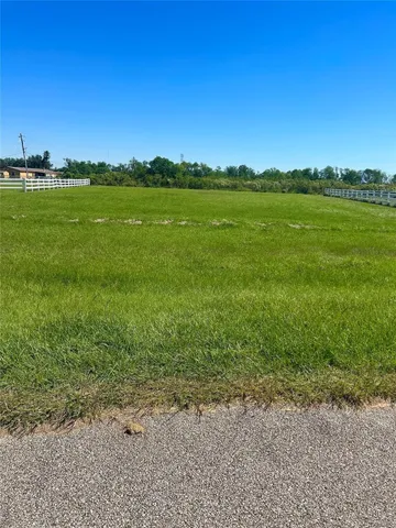 a view of a field with an ocean