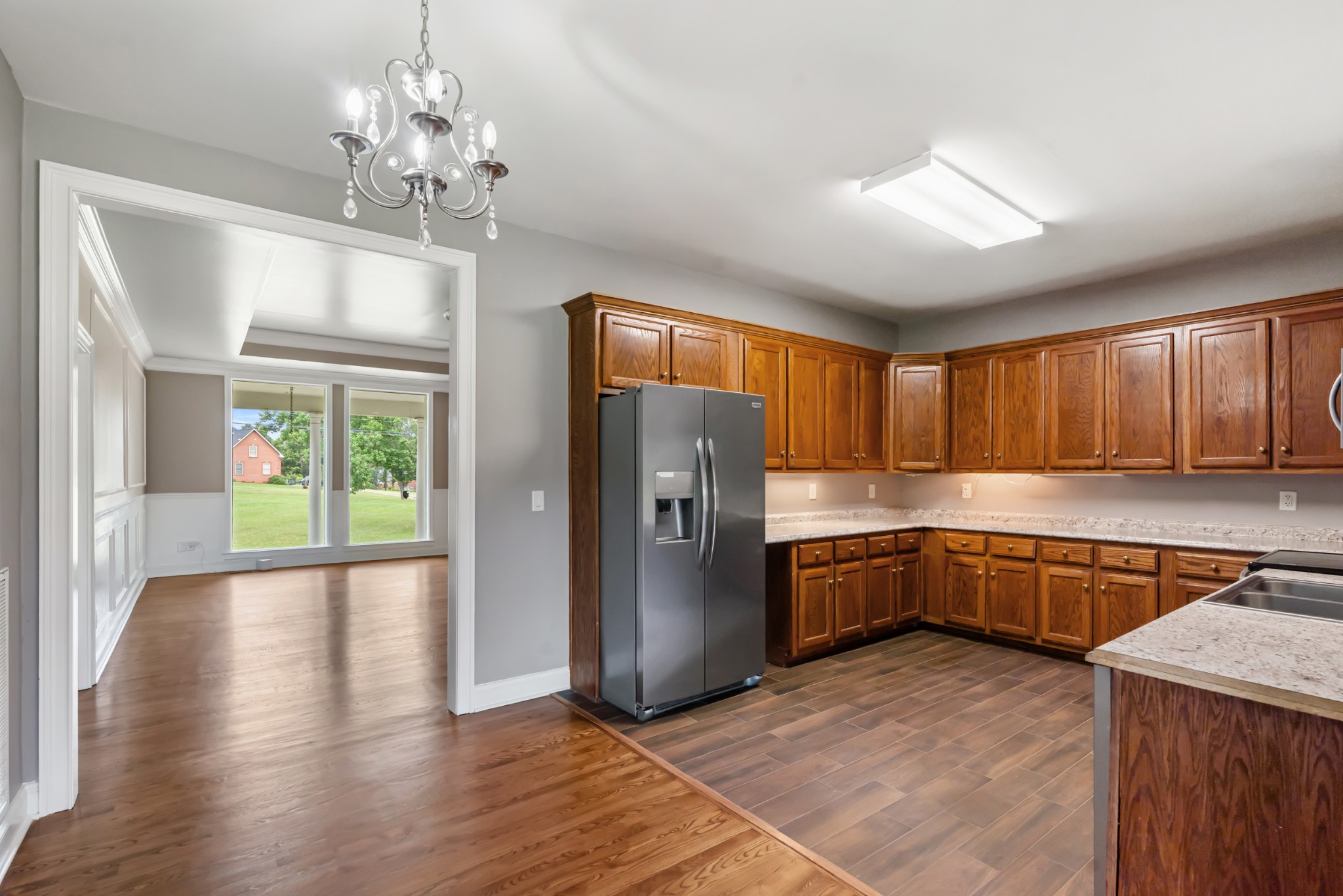 4602 Washington Road Springfield, TN 37172 - Photo 12 of 63 a kitchen with stainless steel appliances granite countertop a refrigerator a sink dishwasher a stove with wooden cabinets and floor