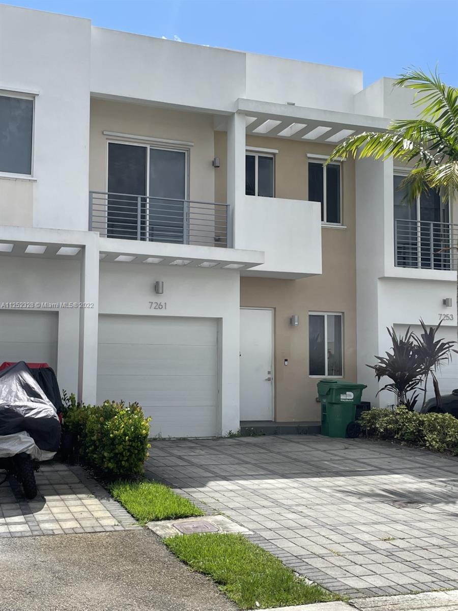 7261 Northwest 103rd Path Doral, FL 33178 - Photo 2 of 10 a front view of a house with a garden