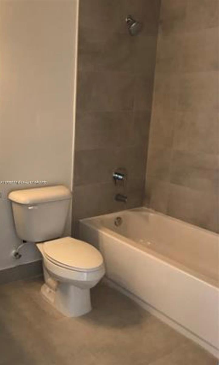 7261 Northwest 103rd Path Doral, FL 33178 - Photo 9 of 10 a white toilet sitting next to a bath tub