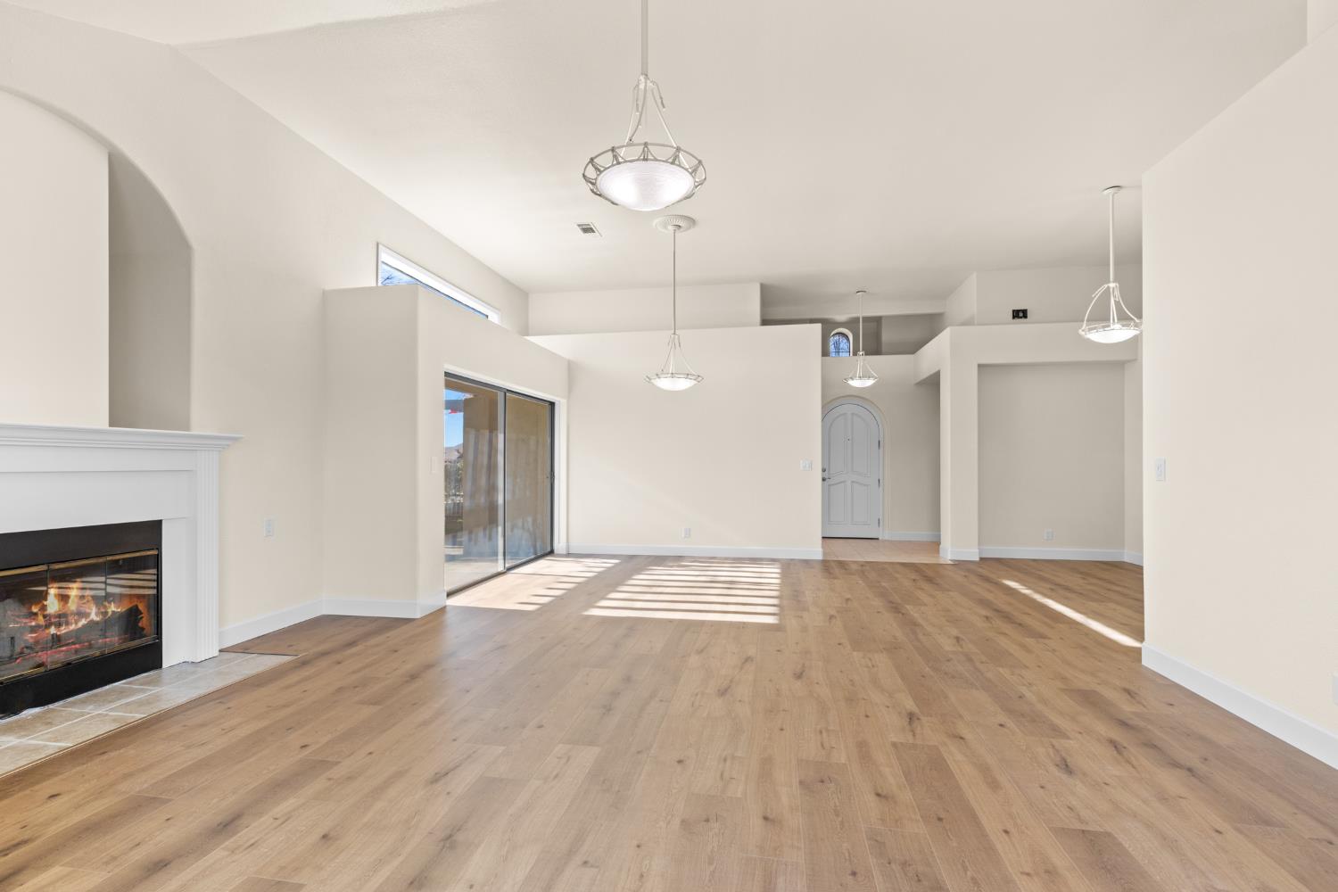 140 Hillside Place Jackson, CA 95642 - Photo 18 of 39 a view of an empty room with wooden floor fireplace and a window