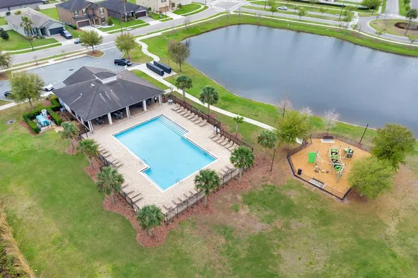 an aerial view of residential houses with outdoor space and river