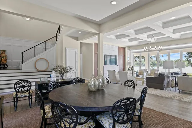 a living room with furniture dining area and a chandelier
