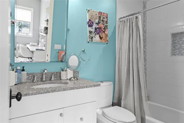 a view of a house with a yard and potted plants