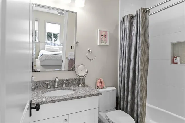 an aerial view of residential houses with outdoor space and lake view