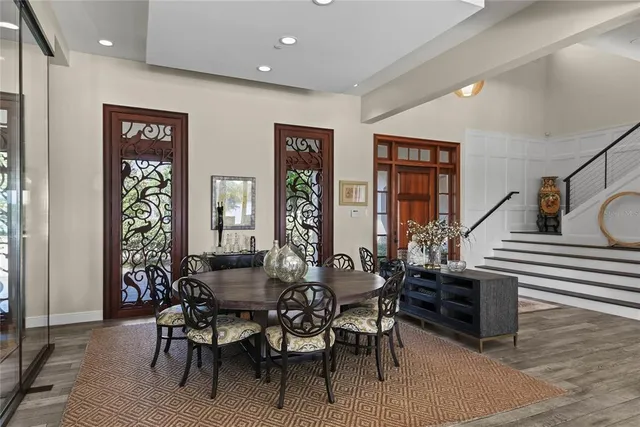 a living room with couch a large window and dining table