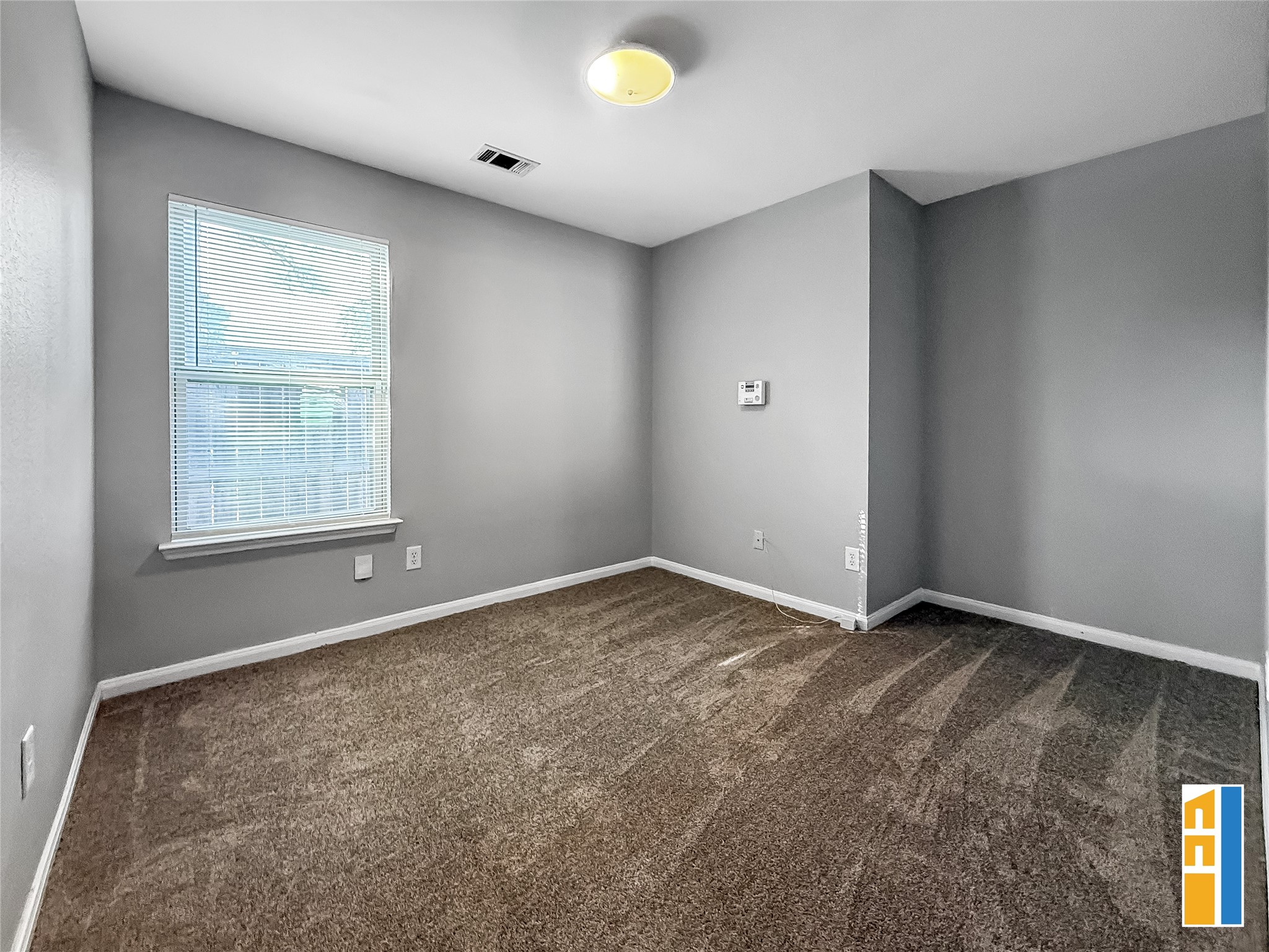 29566 North Legends Bend Drive Spring, TX 77386 - Photo 17 of 21 Discover endless possibilities in this inviting flex room, featuring soft carpeting and ample natural light, perfect for your personalized retreat or home office.