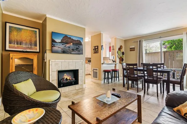 a living room with furniture a table and chairs next to a window