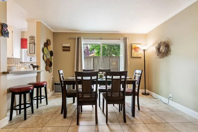 a view of a dining room with furniture and a potted plant