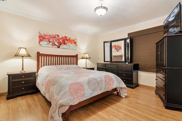 a bedroom with a bed and a night stand