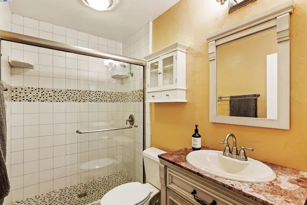 a bathroom with a sink toilet and shower