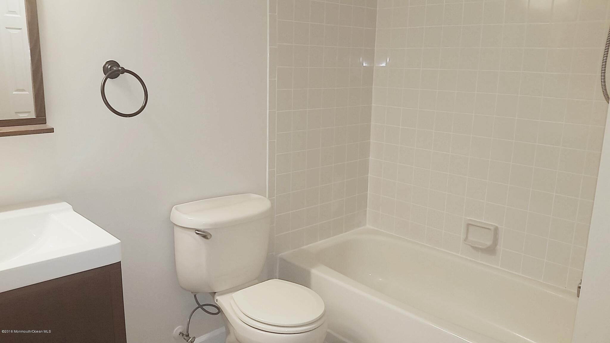 71 Azalea Circle Jackson, NJ 08527 - Photo 21 of 23 a white toilet sitting next to a bath tub