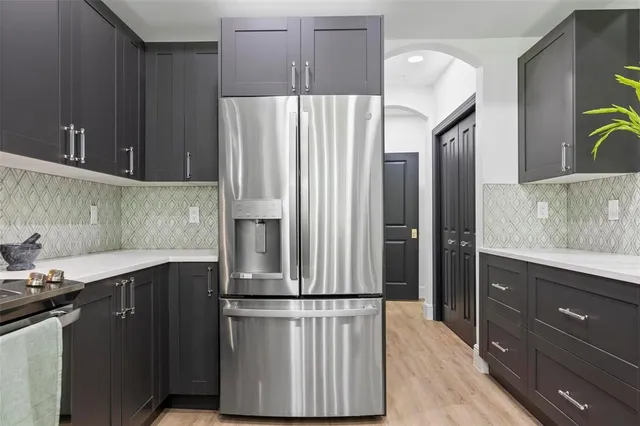 a kitchen with a refrigerator and a sink