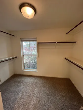 an empty room with a empty space and windows