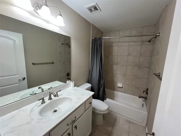 a bathroom with a sink toilet tub and shower