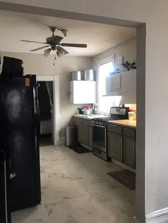 a kitchen with stainless steel appliances kitchen island a refrigerator and a sink