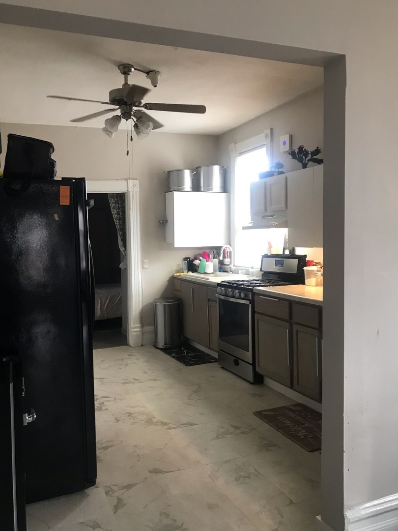1852 West 17th Street Chicago, IL 60608 - Photo 12 of 19 a kitchen with stainless steel appliances kitchen island a refrigerator and a sink