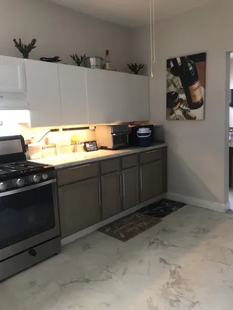 a kitchen with stainless steel appliances granite countertop a sink and a stove