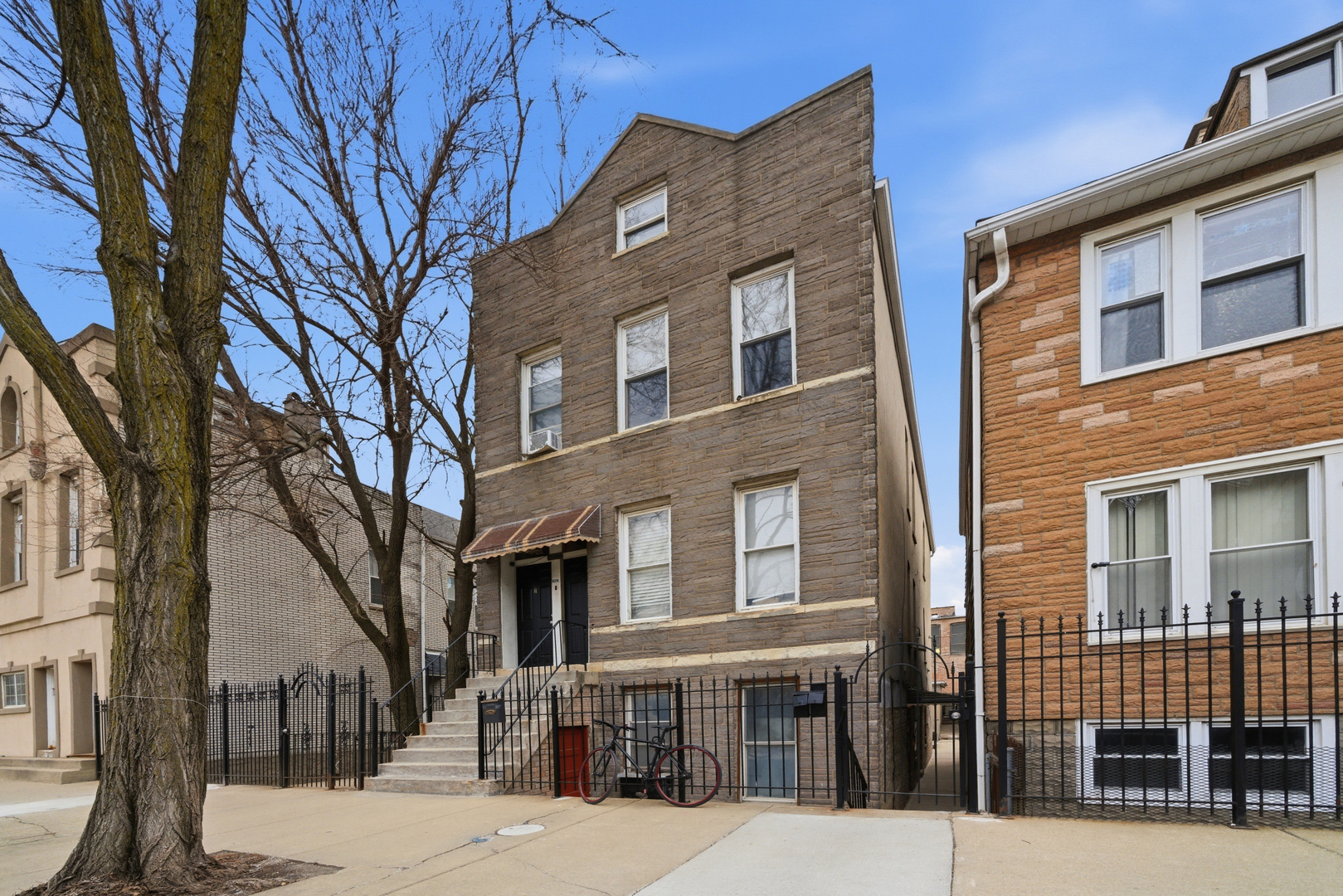 1852 West 17th Street Chicago, IL 60608 - Photo 2 of 19 a front view of a building with a tree