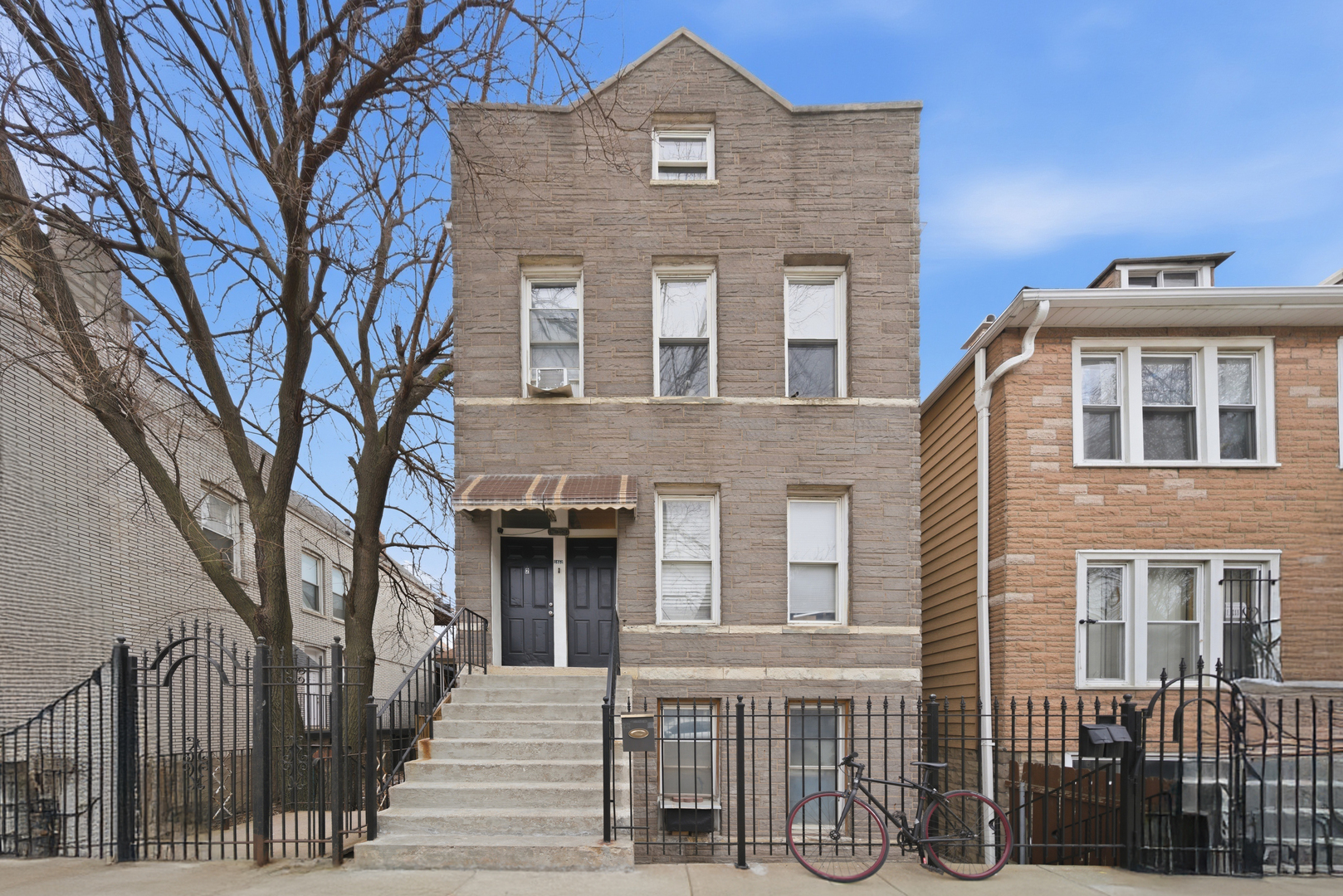 1852 West 17th Street Chicago, IL 60608 - Photo 3 of 19 a front view of a house with a yard