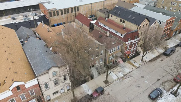 an aerial view of a house with a yard