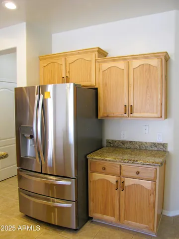 a kitchen with stainless steel appliances granite countertop a refrigerator and a stove