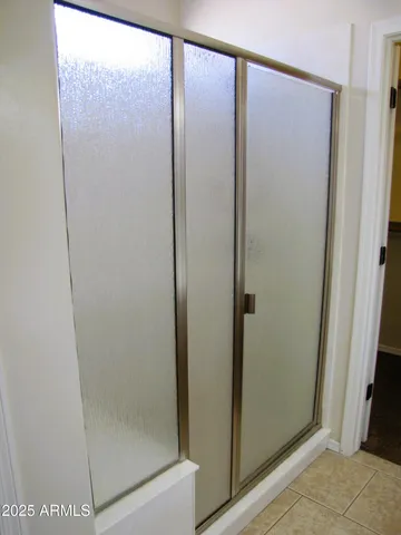 a bathroom with a glass shower door