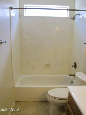 a bathroom with a bathtub and a toilet
