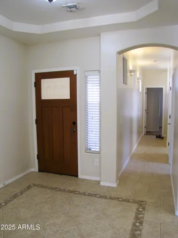 a view of a hallway with wooden shelves