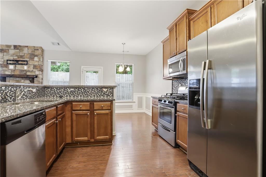 236 Manous Way Canton, GA 30115 - Photo 6 of 25 a kitchen with stainless steel appliances granite countertop a refrigerator a stove and a sink