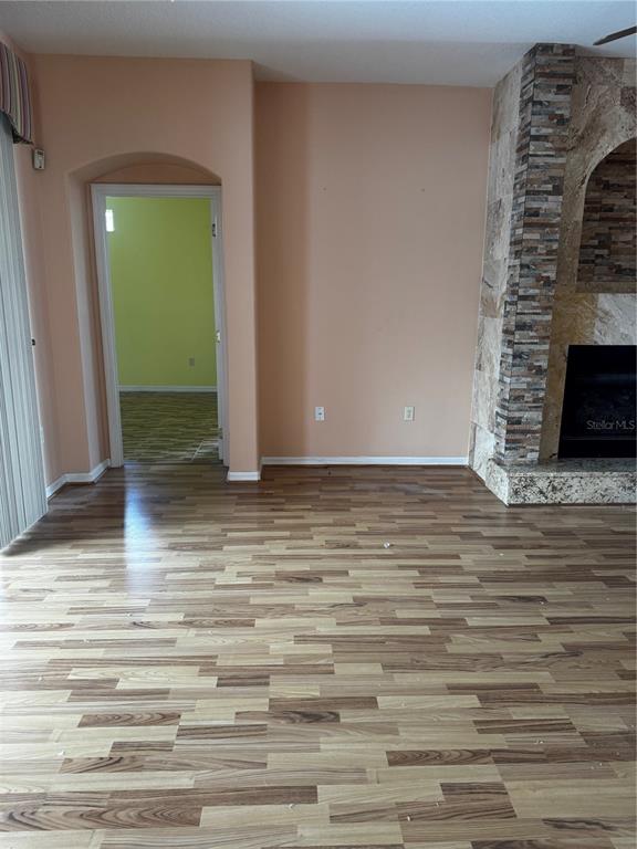 15296 Southwest 15th Terrace Road Ocala, FL 34473 - Photo 15 of 15 a view of a livingroom with wooden floor and a ceiling fan