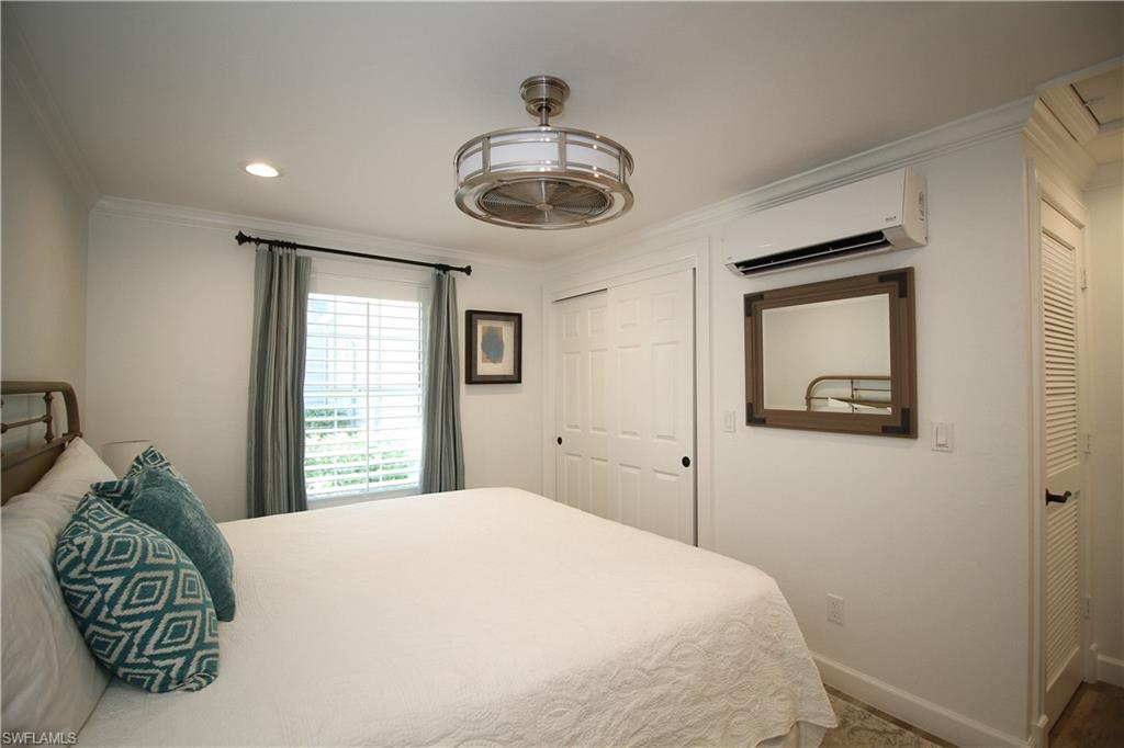 1645 Mullet Court Naples, FL 34102 - Photo 13 of 38 a bedroom with a bed and a window