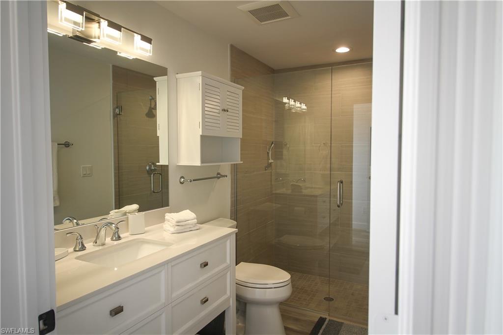 1645 Mullet Court Naples, FL 34102 - Photo 14 of 38 Bathroom with vanity and a stall shower