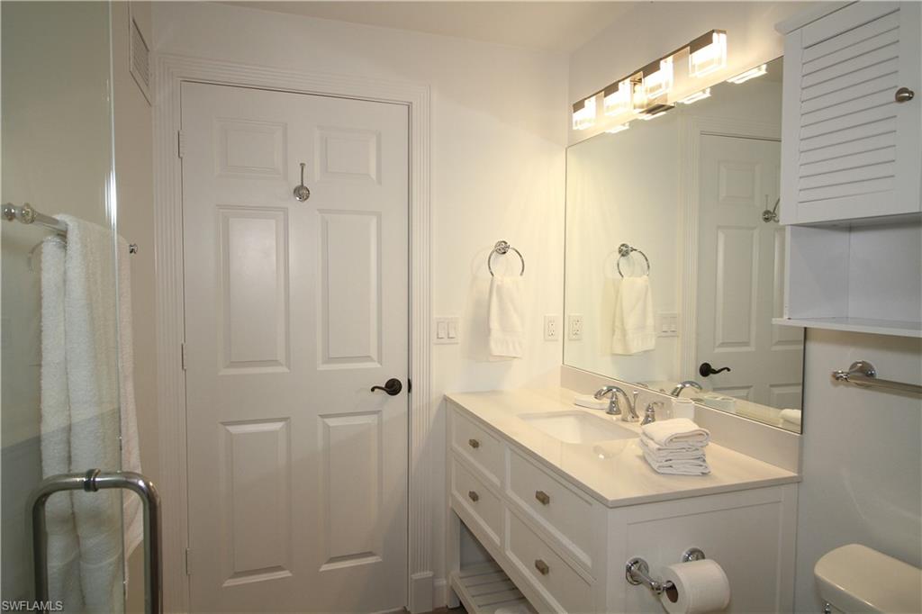 1645 Mullet Court Naples, FL 34102 - Photo 15 of 38 a bathroom with a double vanity sink mirror and toilet