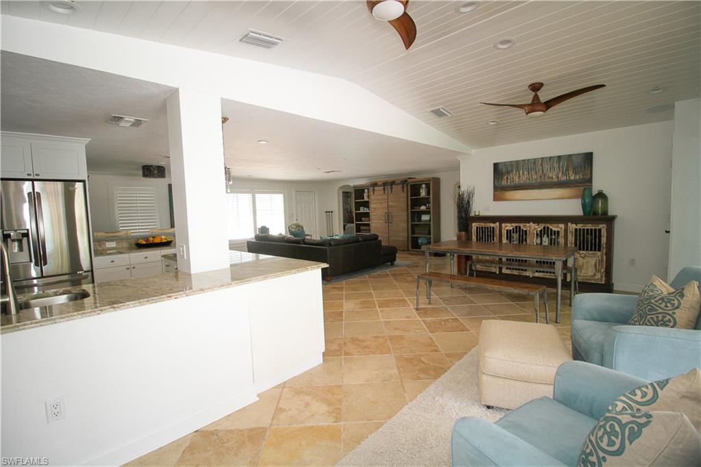 1645 Mullet Court Naples, FL 34102 - Photo 17 of 38 a living room with furniture and a flat screen tv