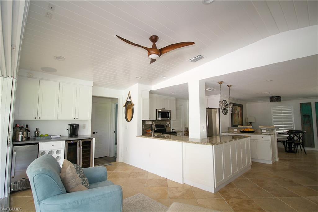 1645 Mullet Court Naples, FL 34102 - Photo 38 of 38 a living room with stainless steel appliances kitchen island granite countertop furniture and a view of kitchen
