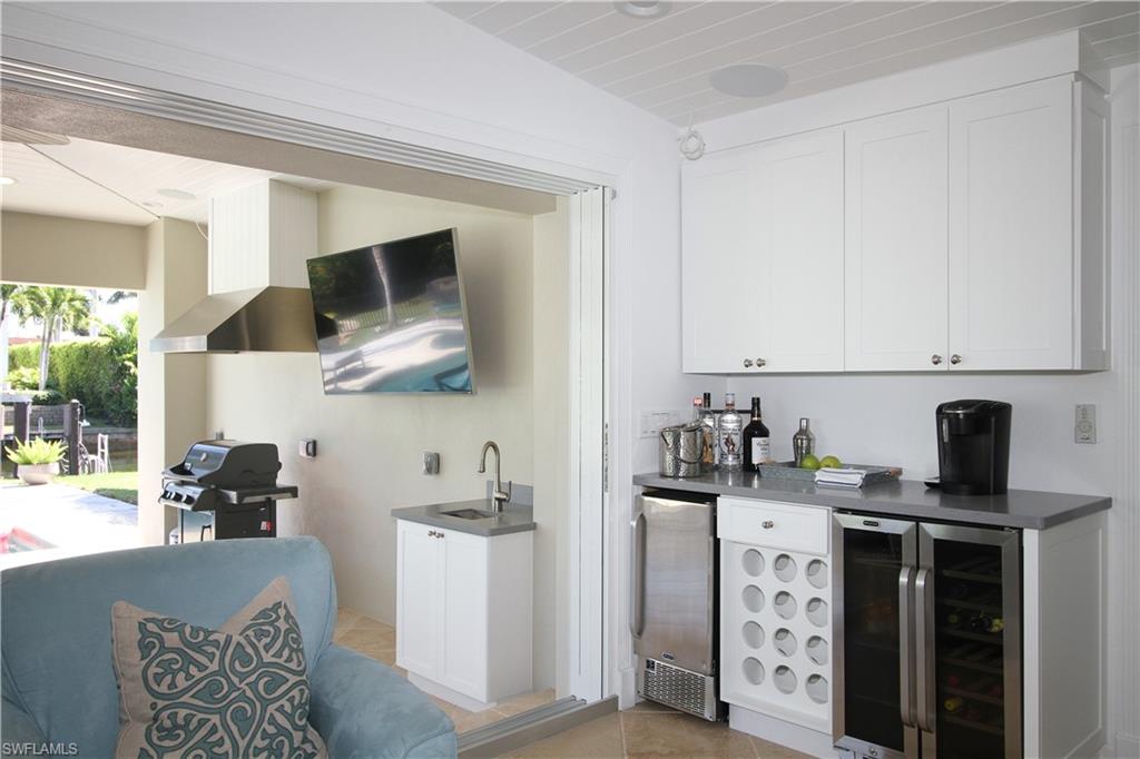 1645 Mullet Court Naples, FL 34102 - Photo 18 of 38 a kitchen with stainless steel appliances kitchen island granite countertop a sink and cabinets