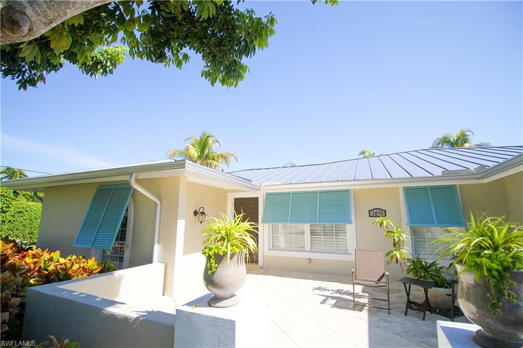 1645 Mullet Court Naples, FL 34102 - Photo 2 of 38 a front view of a house with outdoor seating