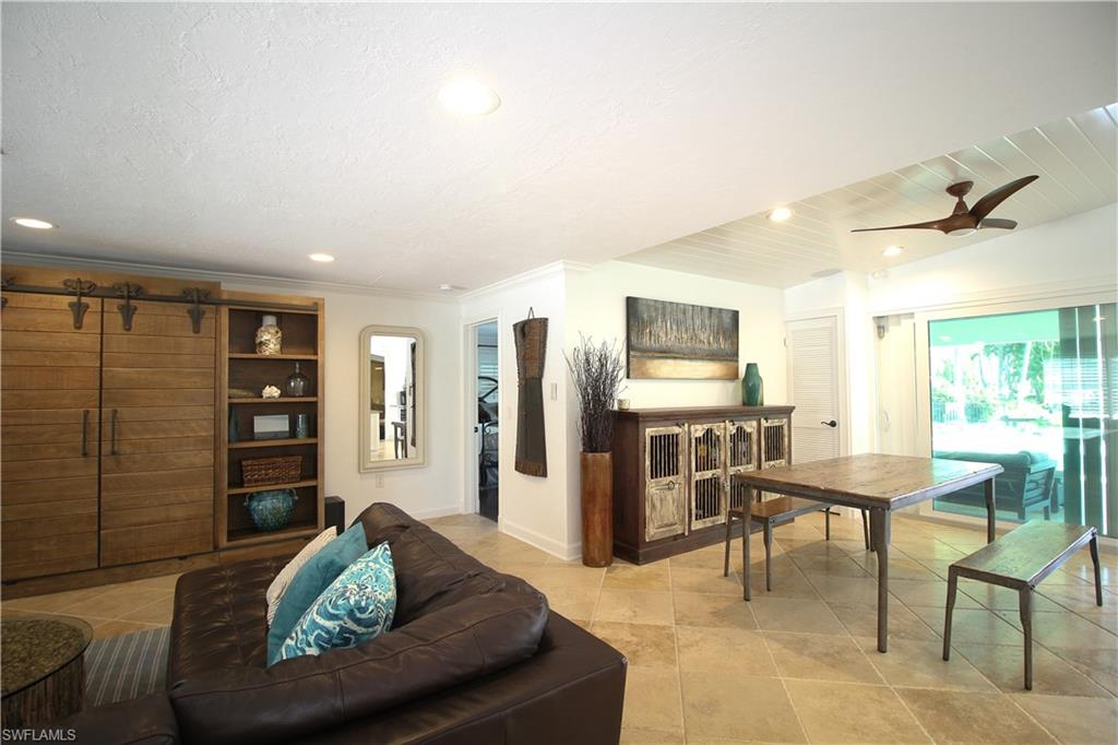 1645 Mullet Court Naples, FL 34102 - Photo 20 of 38 a living room with furniture and outdoor space