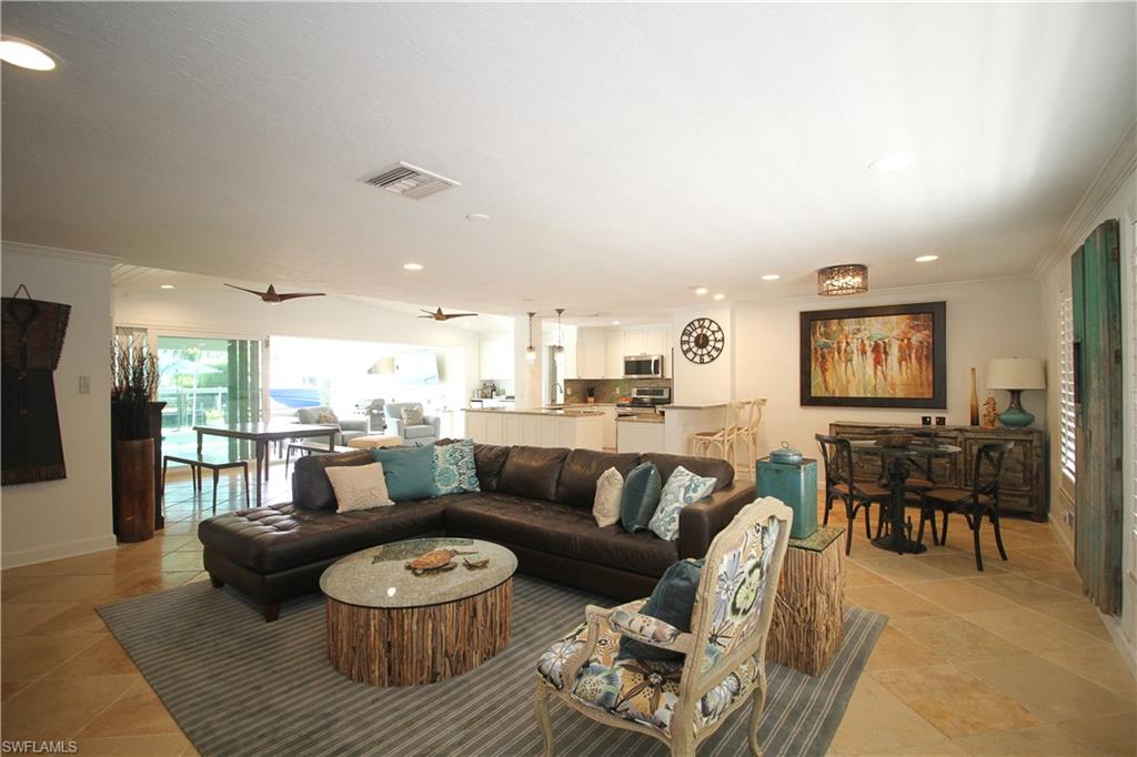 1645 Mullet Court Naples, FL 34102 - Photo 21 of 38 a living room with furniture and a large window