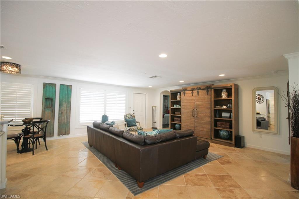 1645 Mullet Court Naples, FL 34102 - Photo 22 of 38 a living room with furniture and large window