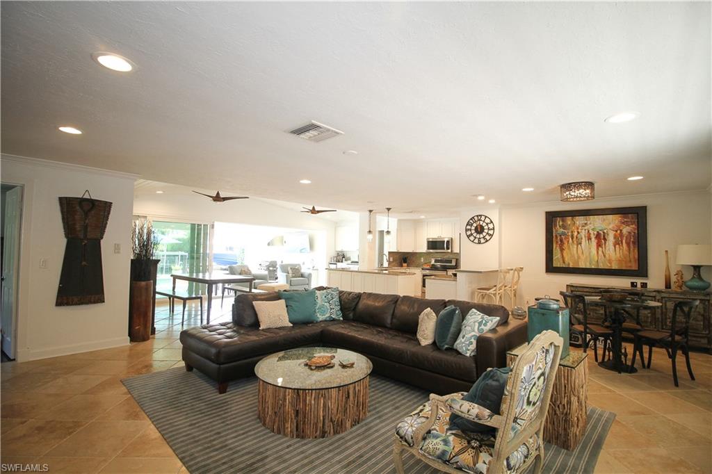 1645 Mullet Court Naples, FL 34102 - Photo 23 of 38 a living room with furniture and a wooden floor