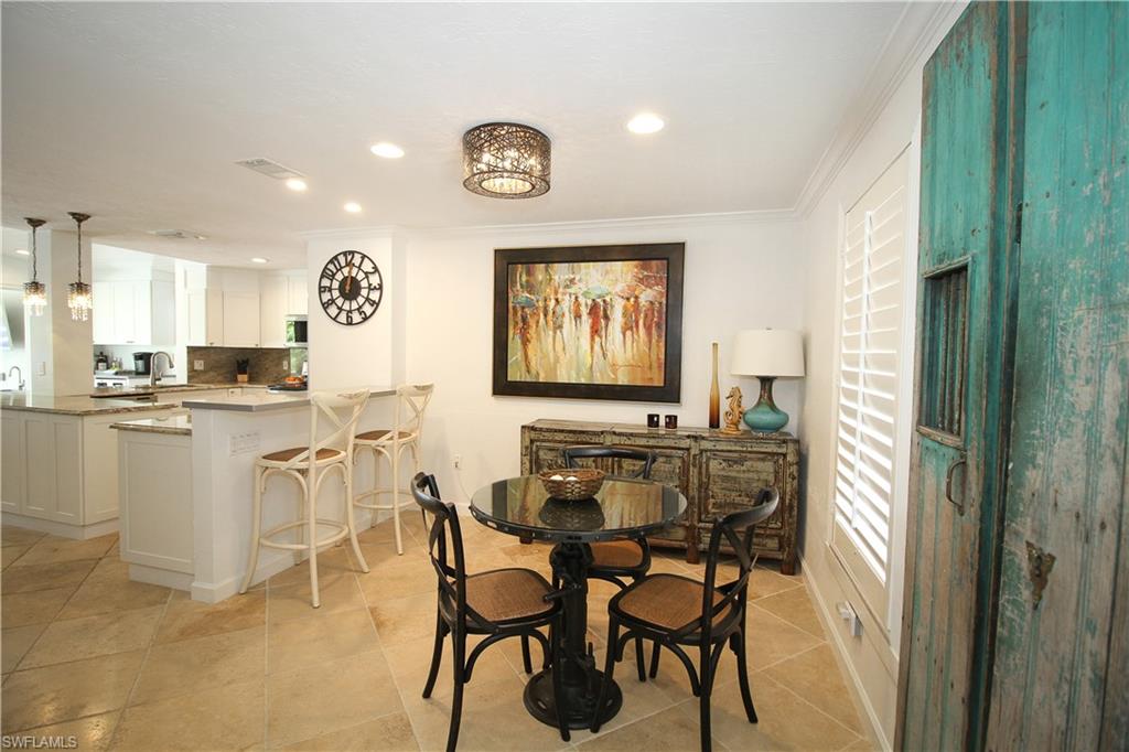 1645 Mullet Court Naples, FL 34102 - Photo 25 of 38 a view of a dining room with furniture and a window