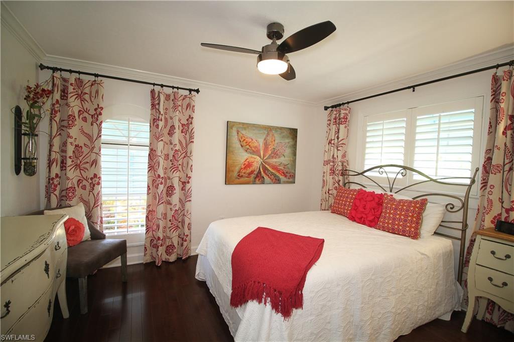 1645 Mullet Court Naples, FL 34102 - Photo 26 of 38 a bedroom with a bed and a large window